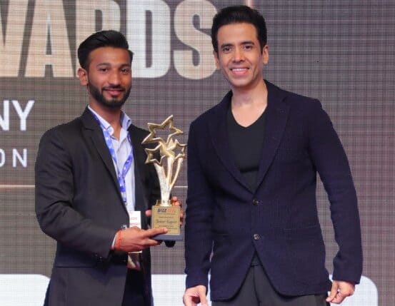 Detective award ceremony with two happy men receiving a trophy on stage.